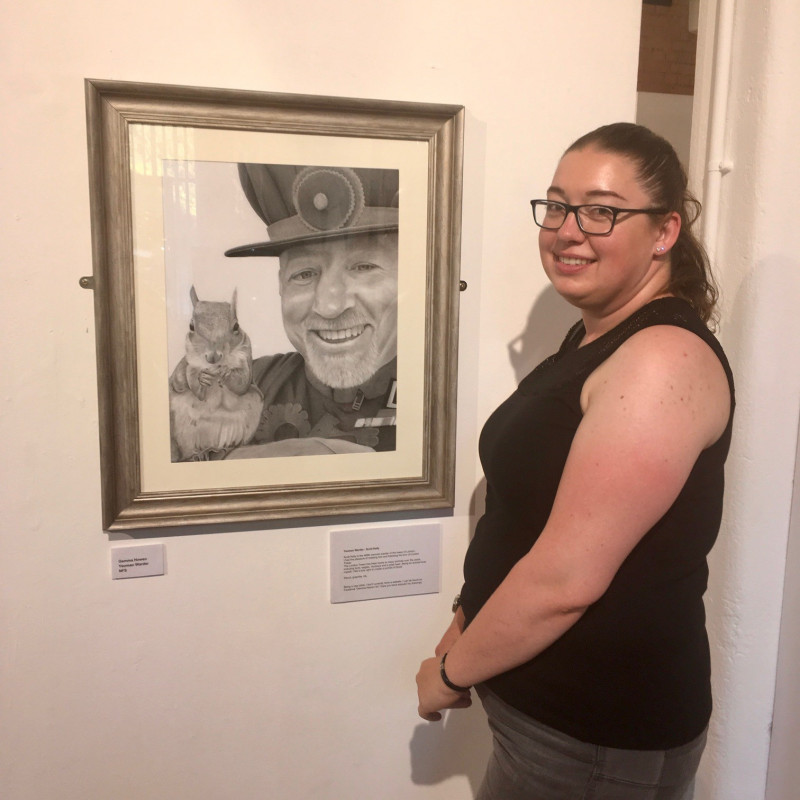 A photo of 'Artist Gemma Howen with her artwork Yeoman Warder- Scott Kelly' by Atkins Building